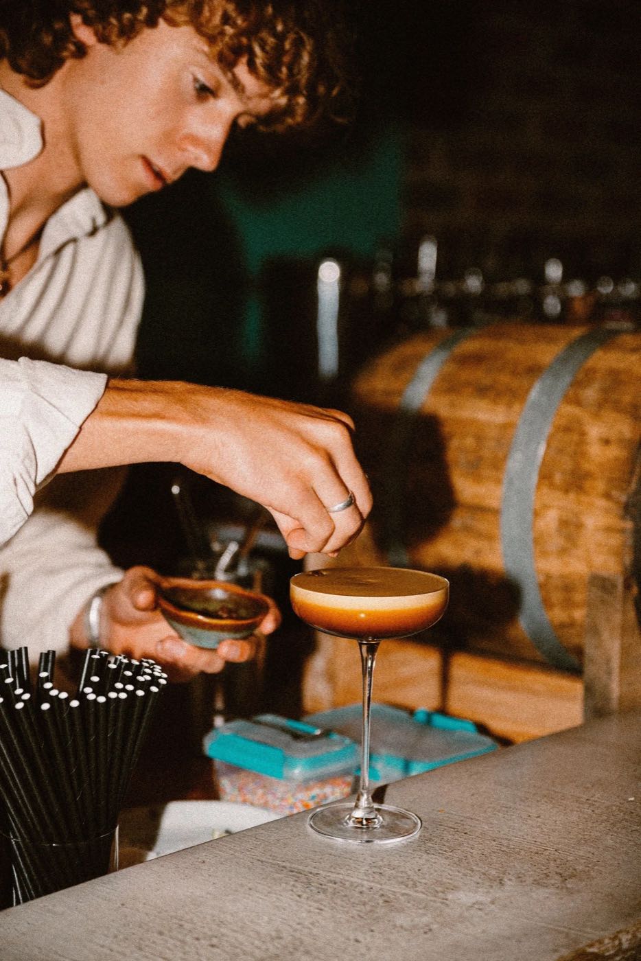A bartender garnishing an espresso martini at Nomy Bar and Kitchen